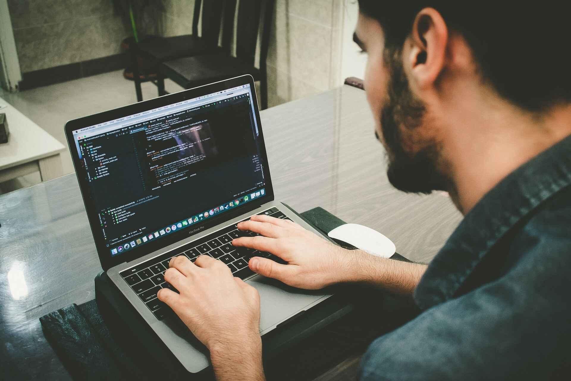 a programmer coding on his computer